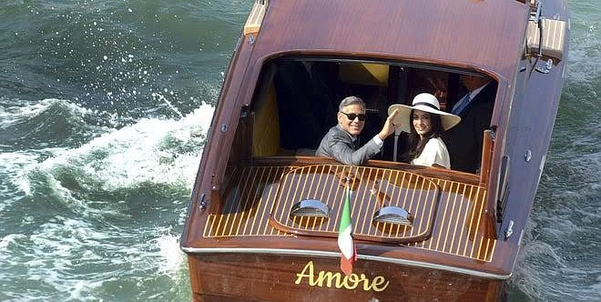 Clooney is arriving up the Grand Canal in a water taxi called Amore