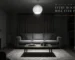 Living room at night lit only by a single central ceiling pendant, corners in shadow